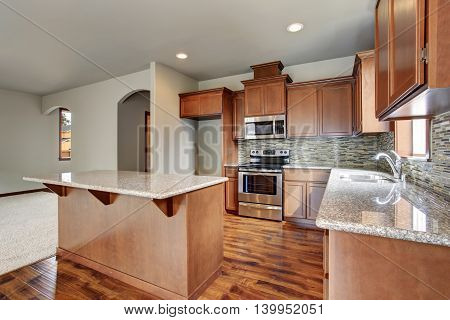 Kitchen Room Interior With Brown Cabinets, Kitchen Island, Granite Counter Tops.