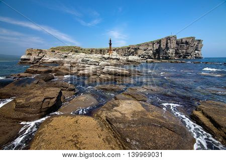 Rocky cape with old lighthouse in Vladivostok, Russia