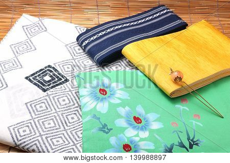 Japanese yukata and a band for men and women on bamboo blinds. Concept of Japanese summer.