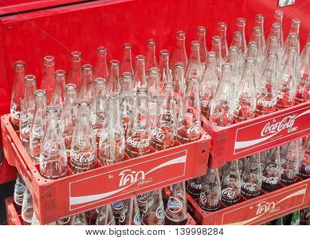 BANGKOK, THAILAND - JUNE 25: Empty recycle bottles of Coca Cola in red plastic box on June 25, 2016 in Bangkok, Thailand. Coca Cola drinks are produced and manufactured by The Coca-Cola Company