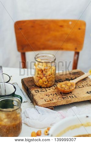 Raspberries Jam. Female Hand Making Jam, On A Rustic White Table