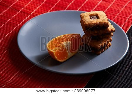 Group Of Chocolate Halloween Cookies On Plate And Red And Black