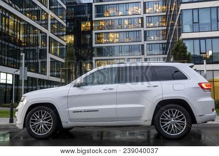 Warsaw, Poland-april 2018: New Suv Jeep Grand Cherokee Model Against The Background Of Modern Buildi