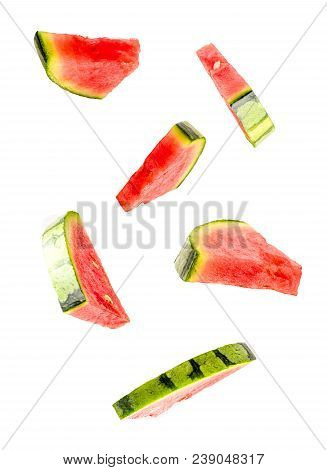 Creative Concept With Flying Watermelon. Sliced Orange Isolated On White Background. Levity Fruit Fl