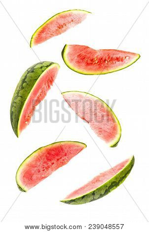 Creative Concept With Flying Watermelon. Sliced Orange Isolated On White Background. Levity Fruit Fl