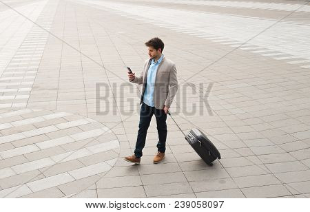 Professionalism Is Inside! Young Businessman Walking At Outdoors With Luggage In The Routine Of Work