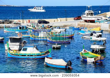 San Pawl, Malta - April 2, 2017 - Traditional Maltese Dghajsa Fishing Boats Moored In The Harbour Wi