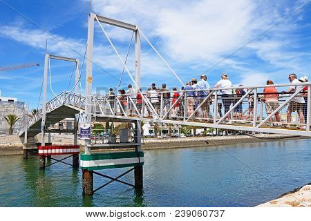 Lagos, Portugal - June 9, 2017 - Pedestrians Waiting For The Footbridge Along The River Bensafrim To