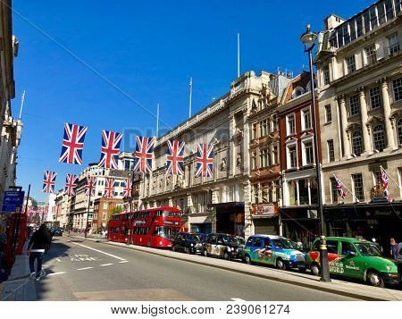 LONDON - MAY 3, 2018: Union Jack flags hanging across Piccadilly in London, UK.