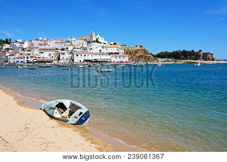 Ferragudo, Portugal - June 10, 2017 - View Of The White Town With Boats Moored On The River Arade, F