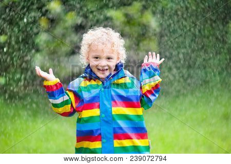 Little Boy Playing In The Rain
