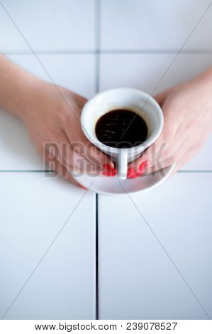 Woman Hand With Red Nails Holding White Cup With Filtered Coffee. On The White Table With Square Lin