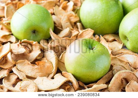 Background Of Sliced Dried Apples And Ripe Green Apples
