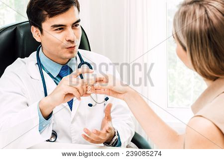 Doctor Holding Pill And Discussing And Consulting With Female Patien On Doctors Table In Hospital.he