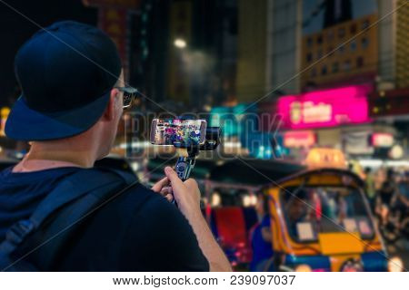 Man Holding A Gimbal In Bangkok In Asia