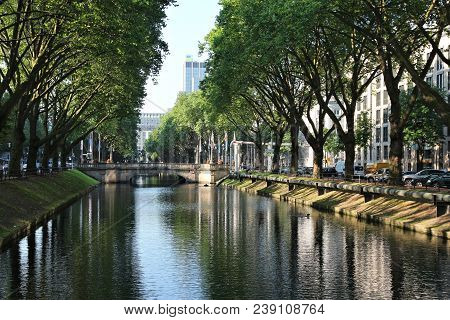 Dusseldorf, Germany - July 8, 2013: People Walk Along Famous Konigsallee Boulevard In Dusseldorf. Ko