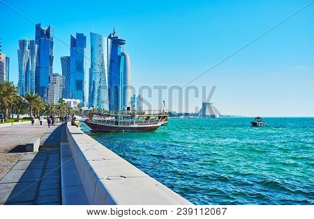 The Pleasure Boats At The Coast Of West Bay, The Glass Skyscrapers Of Al Dafna Business District Are