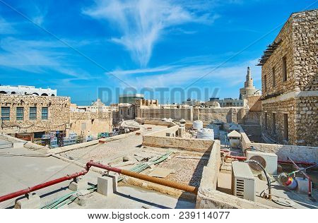 The Walk Along The Old Roofs Of Souq Waqif With A View On Spiral Minaret Of Fanar Mosque On The Back