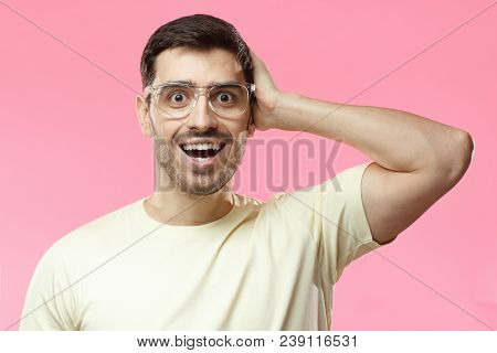 Horizontal Closeup Of Young European Guy Isolated On Pink Background With Beige Casual T-shirt And T