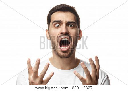 Indoor Picture Of Young Caucasian Guy Pictured Isolated On White Background Shouting With Open Mouth