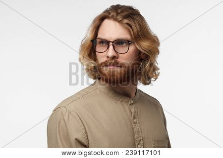 Indoor Studio Photo Of Handsome Scandinavian Man With Face Hair Isolated On Gray Background In Green
