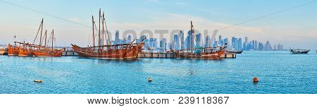 The Walk Along The Coast Of Doha With Picturesque View On Wooden Tourist Boats In Harbor And Modern 