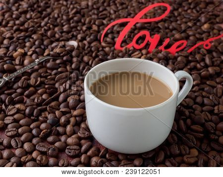 Cup Of Coffee With Milk On Background Of Coffee Beans