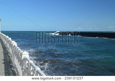 Wonderful Views Of The San Sebastian Bay From Its Promenade And Strong Waves Loading Against Your Br