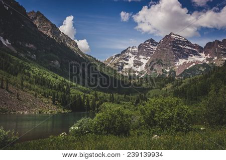 Majestic Maroon Bells Peaks And Maroon Lake On A Sunny Day And Blue Sky In Summer Near Aspen, Colora