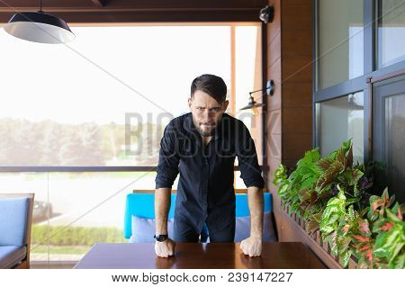 European Businessman Standing At Office And Wearing Black Shirt. Concept Of Responsibility And Succe