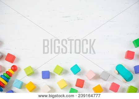 Kids Toys Frame Wooden Blocks, Car, Pyramidion On White Wooden Background. Top View. Flat Lay. Copy 