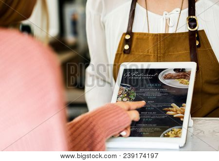 Customer ordering food at restaurant counter