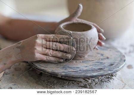Potter Sculpts A Vase On A Potter's Wheel