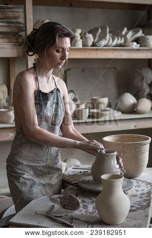 Potter Sculpts A Vase On A Potter's Wheel