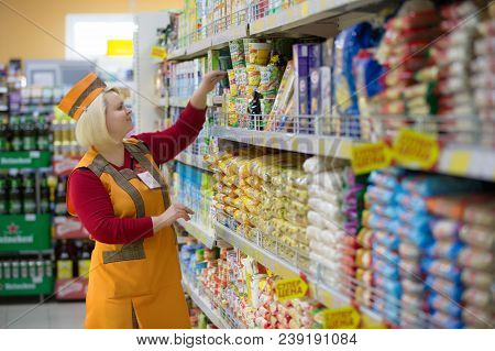 Belarus, Gomel, April 24, 2018. The Shop Is Central. Saleswoman In A Supermarket Near The Shelf With