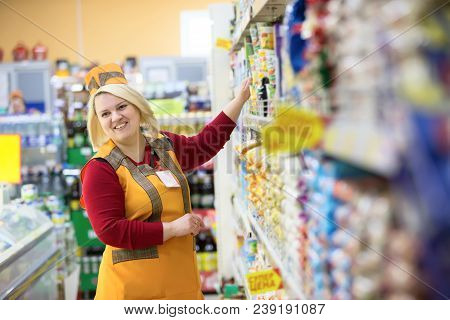 Belarus, Gomel, April 24, 2018. The Shop Is Central. Saleswoman In A Supermarket Near The Shelf With
