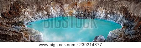 Blue Sulfur Toxic  Lake In The Crater Of The Ijen Volcano. Poisonous Sulfur Smoke. Mountain Volcanic