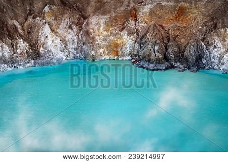 Fragment of blue sulfur toxic lake in the crater of the Ijen volcano. Poisonous sulfur smoke. Mounta
