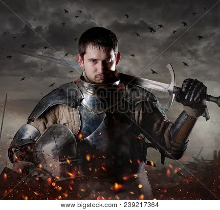 Portrait Of A Knight With Sword On Batllefield. Knight With Sword In Battlefield.