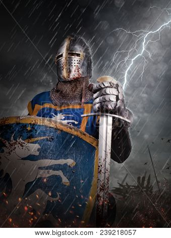 Lightning Strikes A Knight On Battlefield. Knight With Sword In Battlefield.