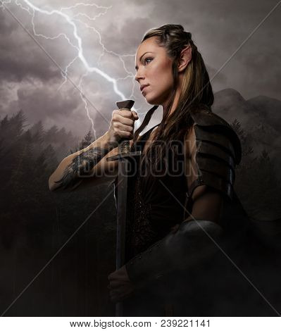 Female Elf Woman Warrior Holding Sword On Lightning Background.