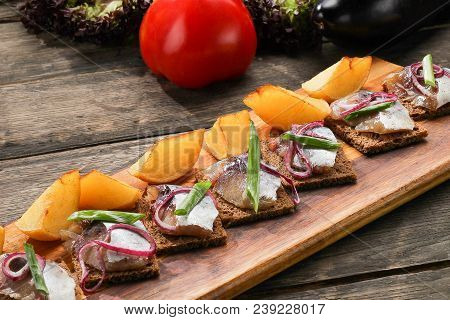 Herring With Baked Potatoes And Onions On Tray On Wooden Background. Restaurant Dish