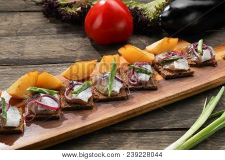 Herring With Baked Potatoes And Onions On Tray On Wooden Background. Restaurant Dish