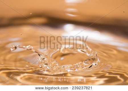 Shining Drop Of Water Colored Of Orange Isolated Composition