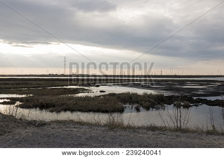 Late At Night. Sundown And Sunrises. River Running Across The Field With Reflections In The Water. E