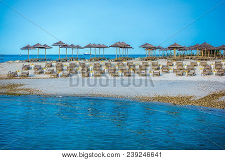 Beach With Beach Chairs In Morning Light On The Beach Of A Croatian Seaside Holiday Resort In Porec,
