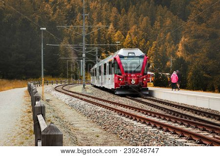 Poschiavo, Grisons, Switzerland - August 10, 2016 : Red Train Of The Rhaetian Railway Entering The S