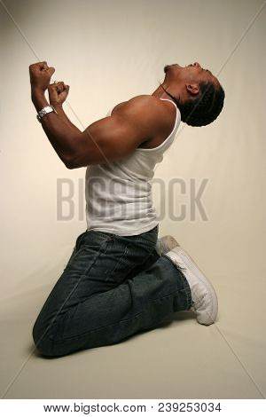 Black Man In Agony On His Knees.