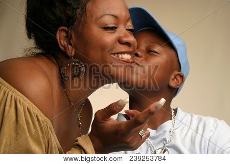 Black Mother And Son Kiss On The Cheek