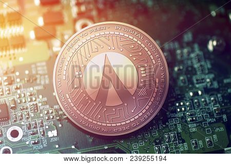 Shiny Copper Dentacoin Cryptocurrency Coin On Blurry Motherboard Background Token
